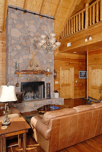 Livingroom fireplace with the vaulted wood ceilings